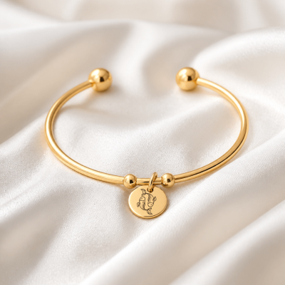 Bracelet jonc et médaillon doré motif astrologique