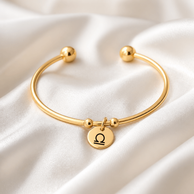 Bracelet jonc et médaillon doré logo astrologique